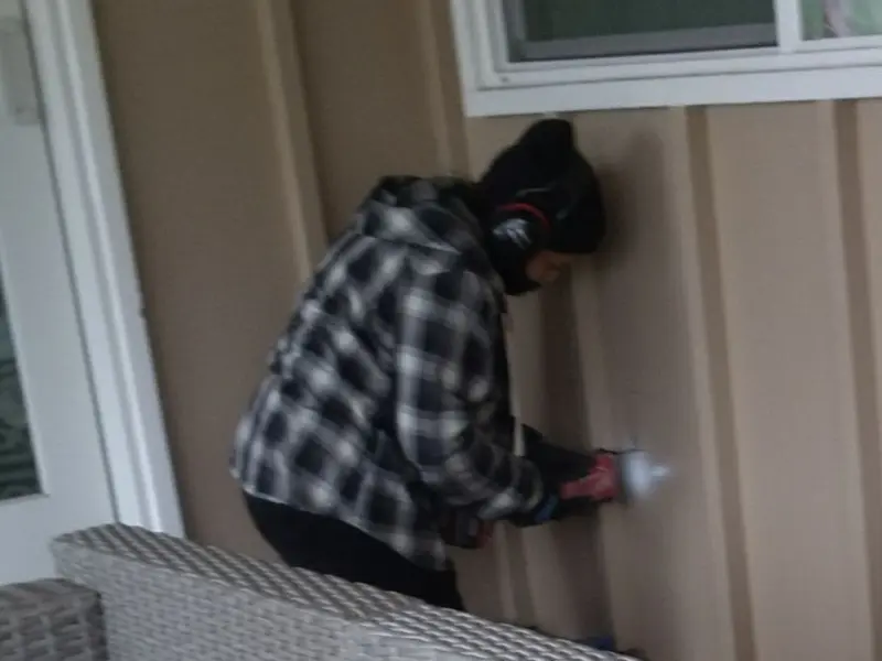 Professional electrician installing an exterior outlet in Lemoyne