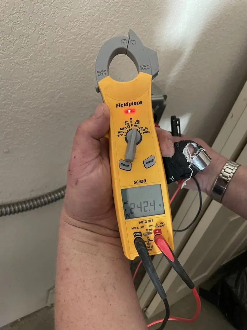 Voltage testing with clamp meter during Electrical Installation Services in Lemoyne